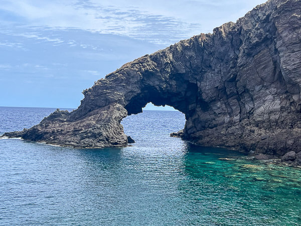 a rock arch in the water in pantelleria called elefant arch