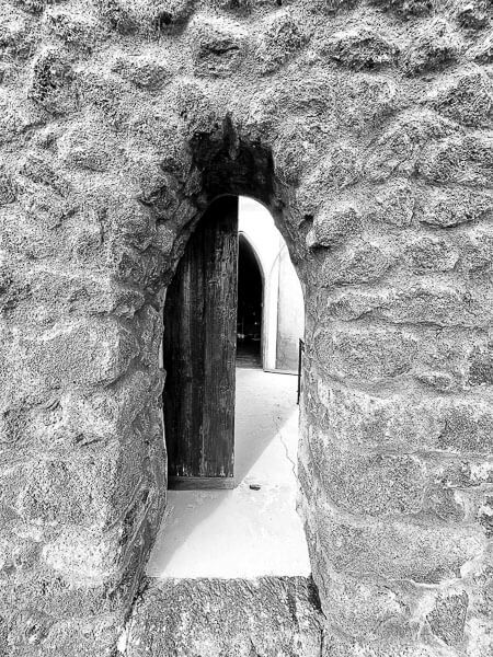 a stone wall with a door opening of a dammuso