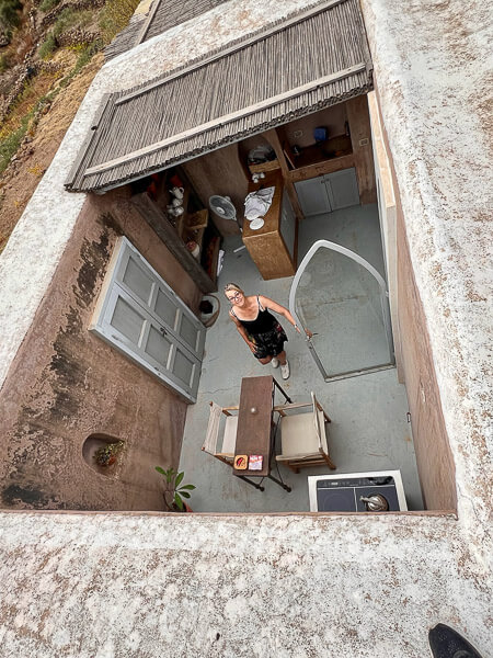 a woman standing in a courtyard of an open kitchen