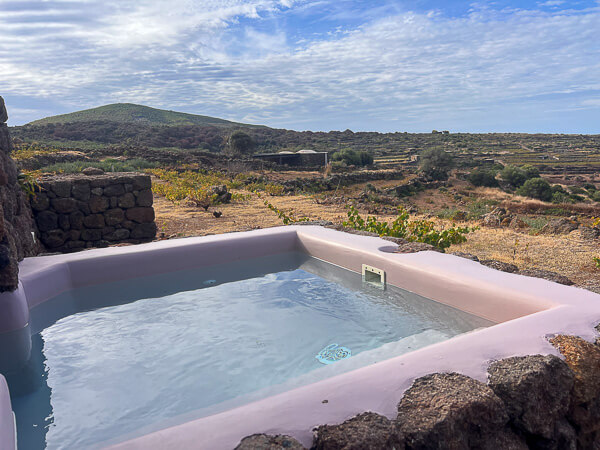 a pool with a stone wall and a stone wall and a stone wall with a stone wall and a stone wall with a stone wall and a stone wall with a stone wall and a stone wall with