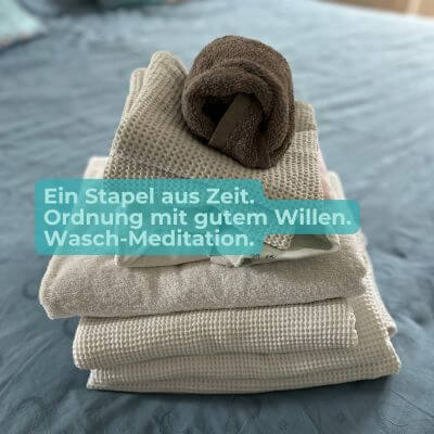 Gefaltete Handtücher auf Bett – Ordnung als kleine Alltagsmeditation